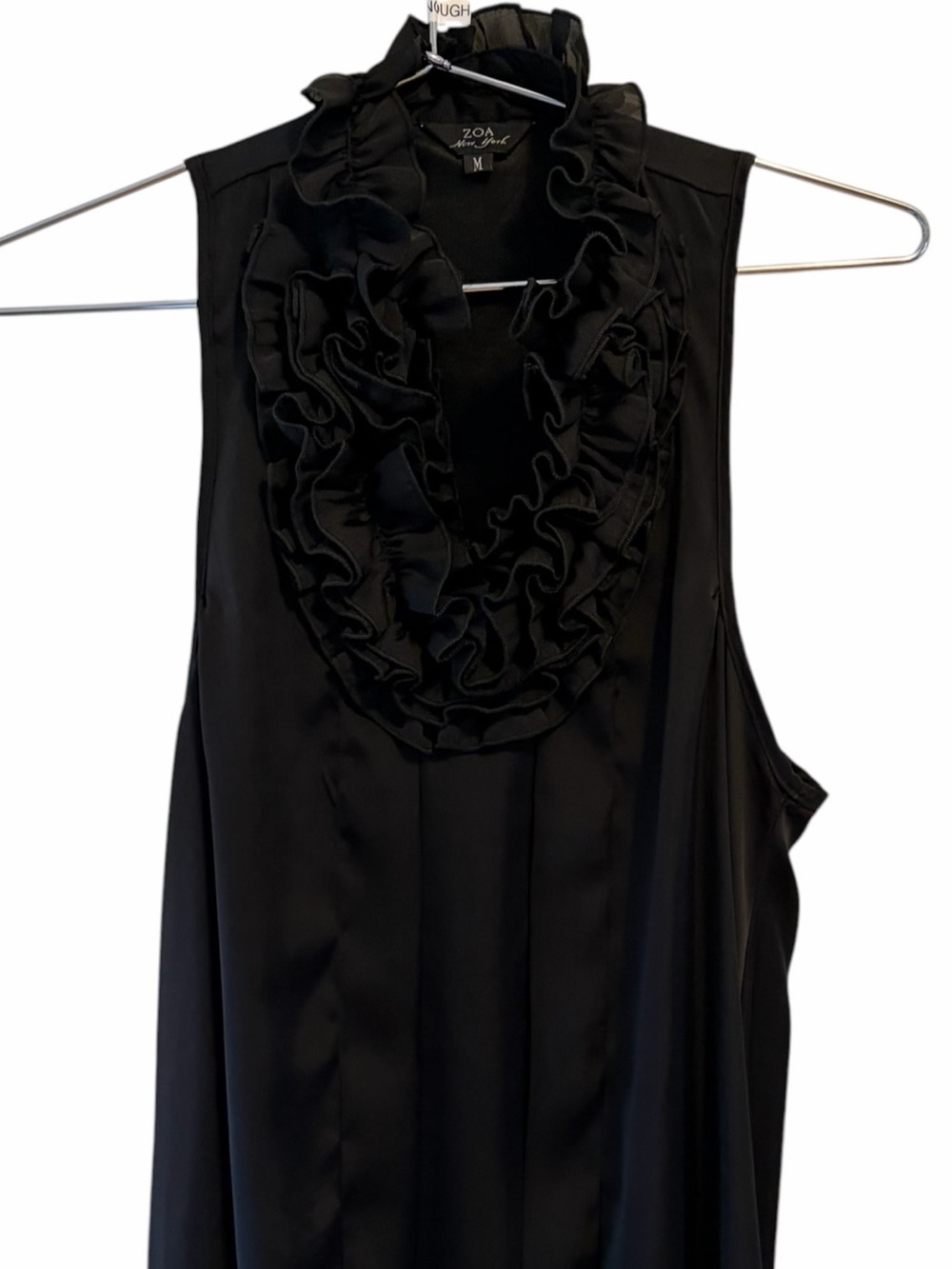 ZOA New York featuring a dramatic, cascading ruffle black silky top